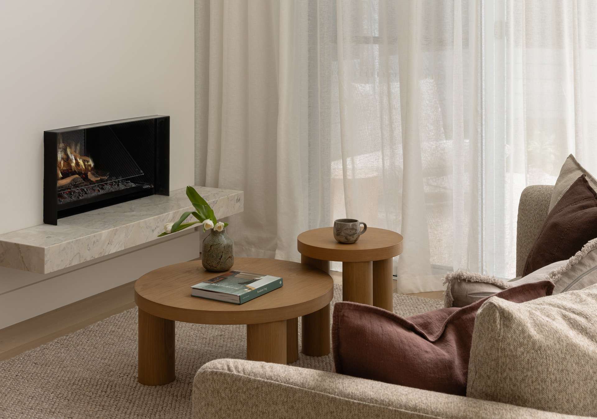 Modern Mediterranean-style duplex with arched windows, neutral tones, and minimalist landscaping